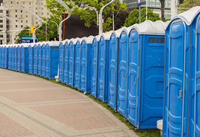 a fleet of portable restrooms ready for use at a large outdoor wedding or celebration in Montebello, CA